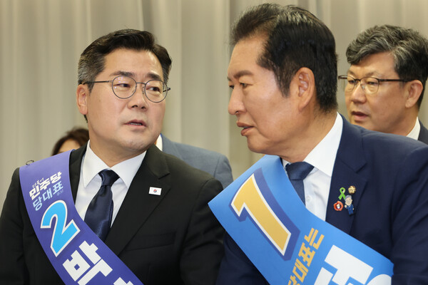 지난 20일 서울 여의도 더불어민주당 중앙당사에서 열린 영남권 합동연설회에서 대화중인 박찬대 후보와 정청래 후보. 연합뉴스. 